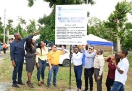 Minister of Water, Environment and Climate Change, Matthew Samuda (centre), turns on a pipe to officially commission the Spring Garden Water Supply System. Looking on are Mayor of Montego Bay and Chairman of the St. James Municipal Corporation Councillor Richard Vernon (left); Chief Executive Officer of the St. James Municipal Corporation, Naudia Crosskill (second left); Member of Parliament (MP) for St James Southern Nekeisha Burchell (third left); former MP, Homer Davis (fourth right); and other stakeholders. (Photo: JIS)