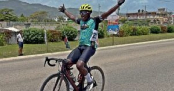 Melvin McFarlane of Elevation Cycling Club raised his arms aloft to roars of applause after crossing the finish line in first place at the Jamaica National Road Race Championship. Photo: OHN