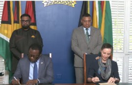President Irfaan Ali (left) and Prime Minister Andrew Holness watching as their foreign ministers sign the various agreements on Friday (CMC Photo)