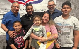 Prime Minister John Briceno (Left) and Immigration Minister Kareem Musa (right) pose with a family who received their Belizean passports during a ceremony in Texas