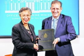 Cabinet secretary Nicole Campbell and Tribune president and Bahamas Aviation, Climate and Severe Weather Network Ltd (BACSWN) founder Robert Carron during the heads of agreement signing ceremony between the government of The Bahamas and BACSWN at the Office of The Prime Minister