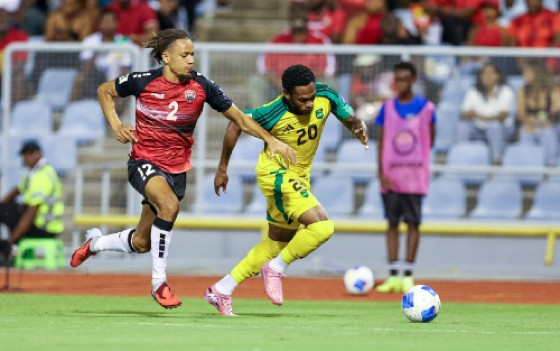 Jamaica’s goal scorer Renaldo Cephas (right) battles with T&T’s Deron Payne for possession. (Photo courtesy CONCACAF)