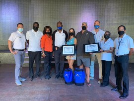 Captains Valerie Talbot and Eric Larson holding plaques.