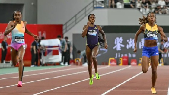 Nickisha Pryce (left) crosses the finish line to win the women’s 400m