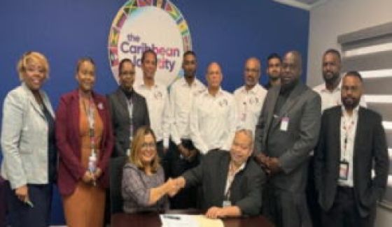 Chief Operations Officer (CAL) Nirmala Ramai (seated left) TTALPA chairman Jason Wickham (seated right) shake hands after singing the agreement, while surrounded by CAL and TTALPA officials, at CAL’s Piarco head office on Monday (CAL Photo)
