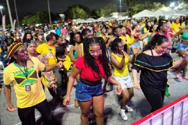 Reggae Genealogy attendees do the Electric Slide while the crowd looks on in the background.| Photo: RJ Deed (Island Syndicate)