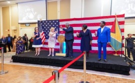 United States Ambassador to Guyana, Sarah Ann-Lynch and Prime Minister Mark Phillips toast as they extend best wishes