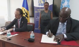 United Nations Resident Coordinator for Barbados and the Eastern Caribbean, Simon Springett, (left) and Permanent Secretary in the Ministry of Health and Wellness, Wayne Marshall, signing the agreement, aimed at strengthening and improving the Queen Elizabeth Hospital.