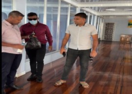 Opposition Leader Azruddin Mohamed (right) watches as members of the Special Organised Crime Unit (SOCU) search his business in the capital (CMC Photo)