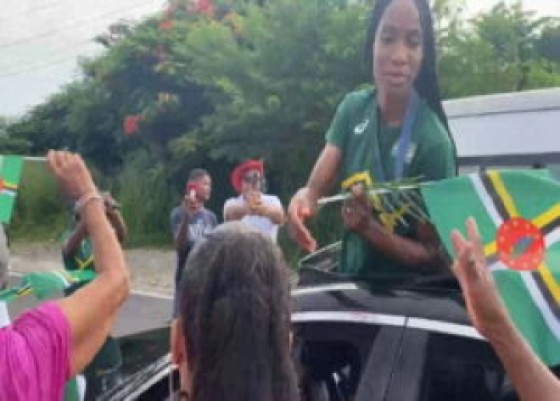 Dominica’s first ever Olympics medalist, Thea Lafond greeting people during the motorcade on Sunday (CMC Photo)