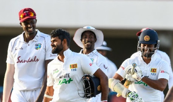 Jason Holder (left) shares a laugh with Sri Lanka’s openers Lahiru Thirimanne (centre) and Dimuth Karunaratne at the close of play Thursday.